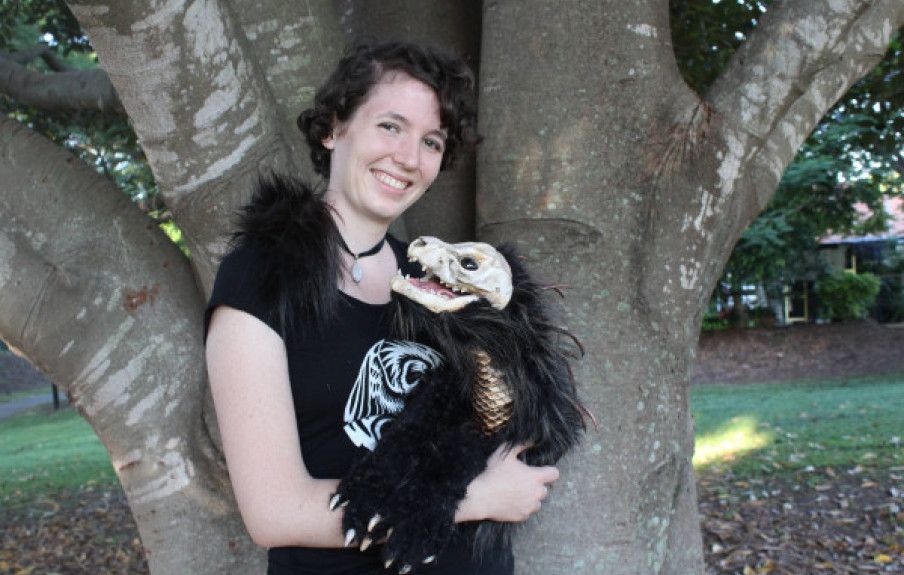 Sonja, a young woman, holds one of her creatures with a skull and wings