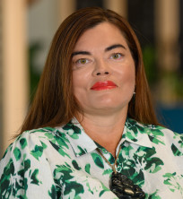 Photo of Ronelle - a woman with long brown hair wearing a green and white shirt